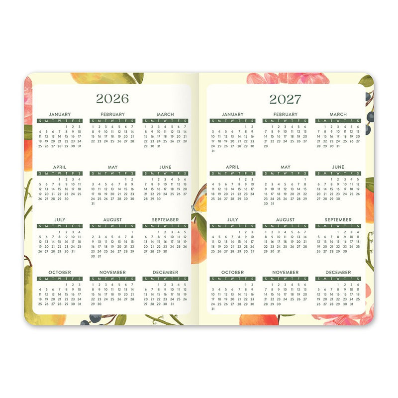 Orange Circle 2027 Monthly Pocket Diary 114 x 165mm Month To View Fruit And Flora shown from a second angle, the Fruit And Flora design, a bright botanical mix of fruit and flowers, with the spine and page block edge visible.
