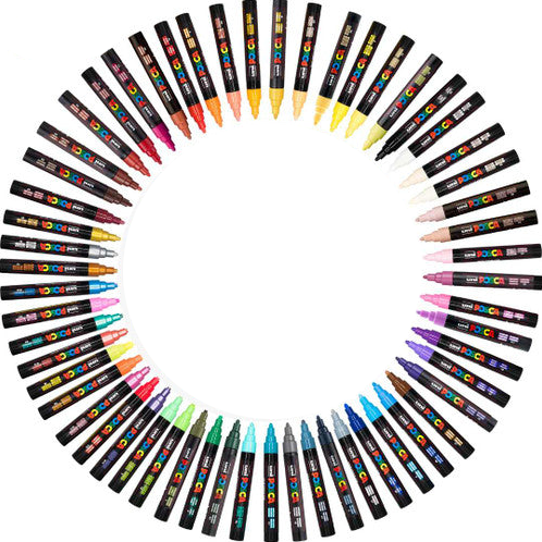 A circular arrangement of 36 posca bullet tip paint markers with various colours visible at the tips, set against a plain white background.