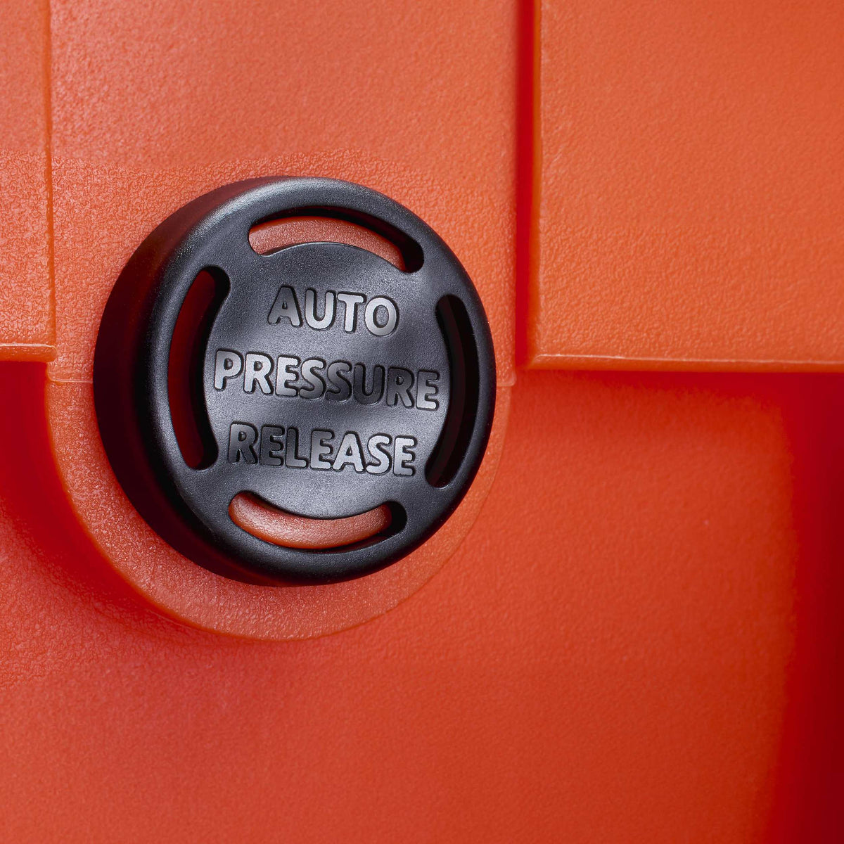 Close-up of the AUTO PRESSURE RELEASE valve, photographed on an orange MAX case