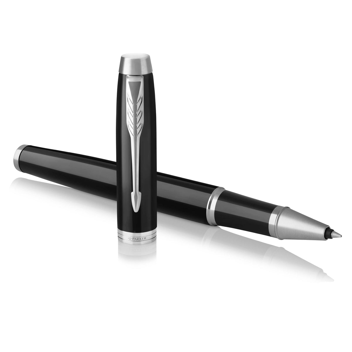 Black IM rollerball lying across its upright cap, chrome clip and tip pointing right