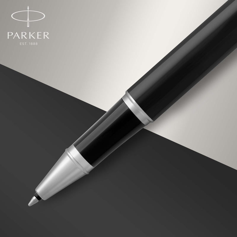 Close-up of the chrome coated section and rollerball tip of the black IM on a dark background