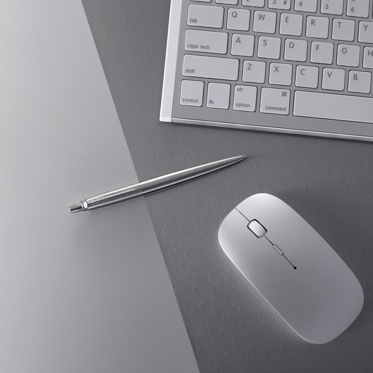 Steel Jotter ballpoint lying on a grey desk beside a keyboard and a white mouse