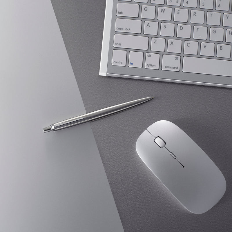 Steel Jotter ballpoint lying on a grey desk beside a keyboard and a white mouse