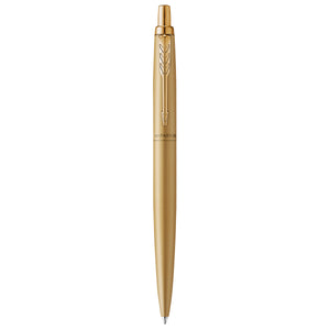 Parker Jotter XL Monochrome in matte gold standing upright on white, gold clip and click button