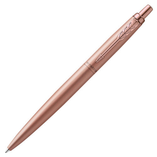 Rose gold Jotter XL lying diagonally with the clip at the top right and the tip at the lower left