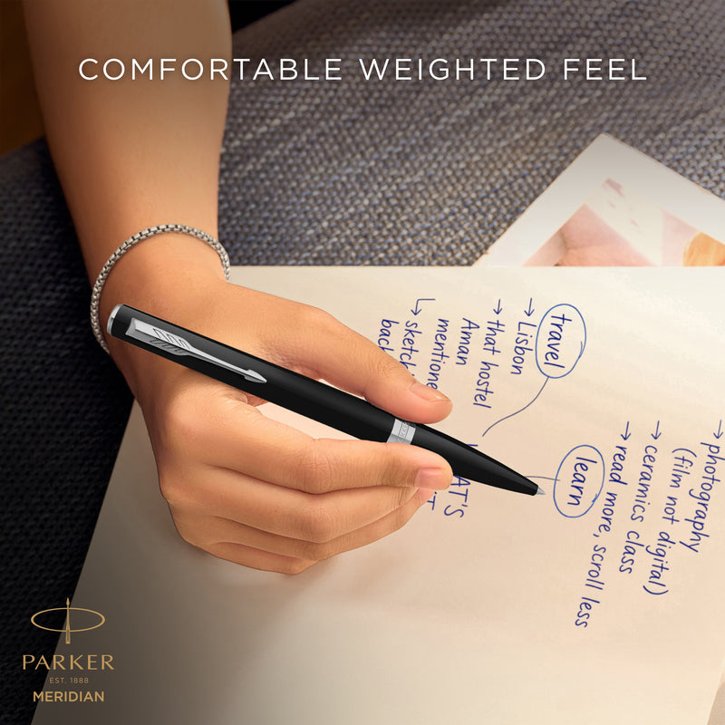 Hand writing with the black Meridian ballpoint, captioned comfortable weighted feel
