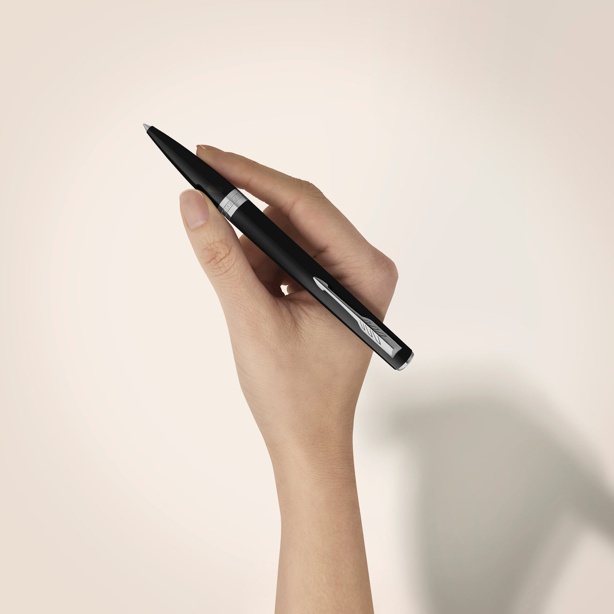 Black Meridian ballpoint in a styled desk setting, showing the chrome clip and centre band