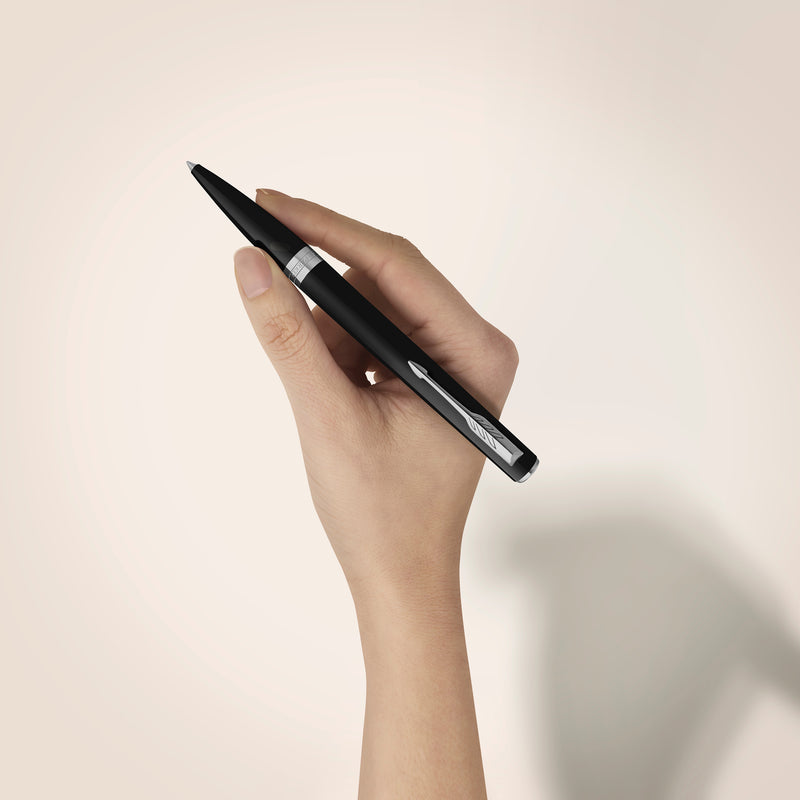 Black Meridian ballpoint in a styled desk setting, showing the chrome clip and centre band