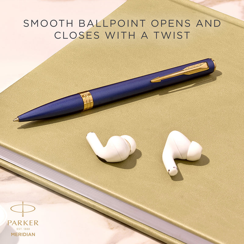 Blue Meridian ballpoint resting on a desk, with Parker's caption that the smooth ballpoint opens and closes with a twist