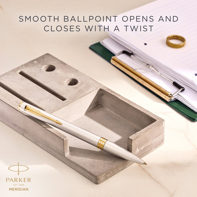 Chrome Meridian ballpoint resting on a desk, with Parker's caption that the smooth ballpoint opens and closes with a twist