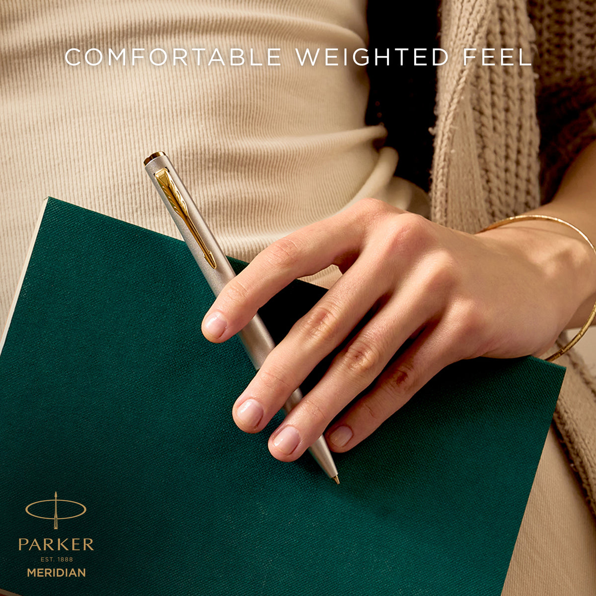 Hand writing with the chrome Meridian ballpoint, captioned comfortable weighted feel
