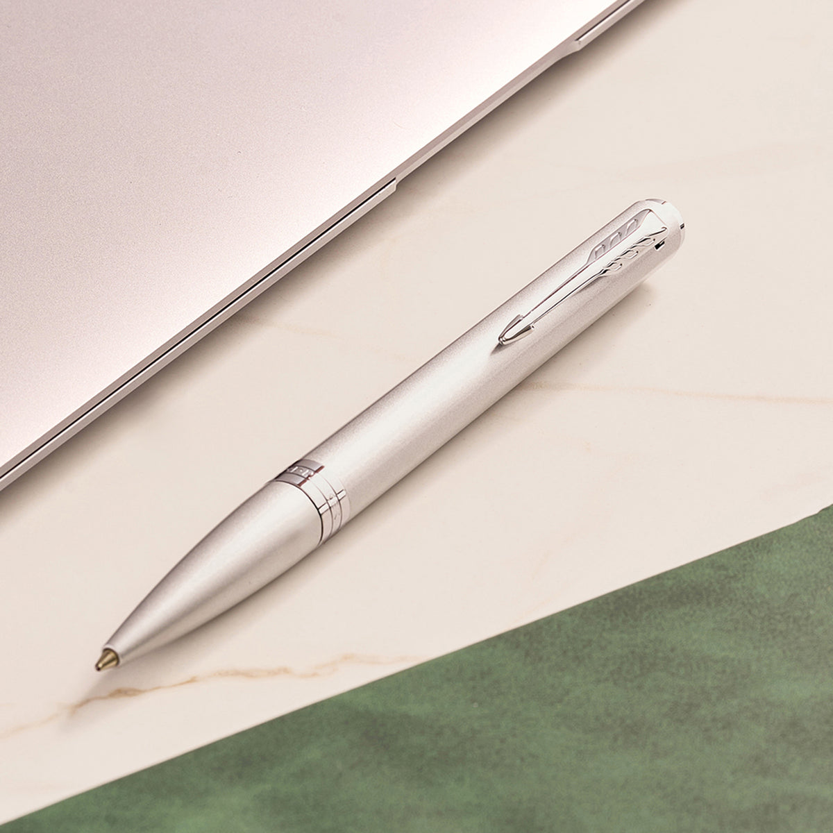 Chrome Meridian ballpoint in a styled desk setting, showing the chrome clip and centre band