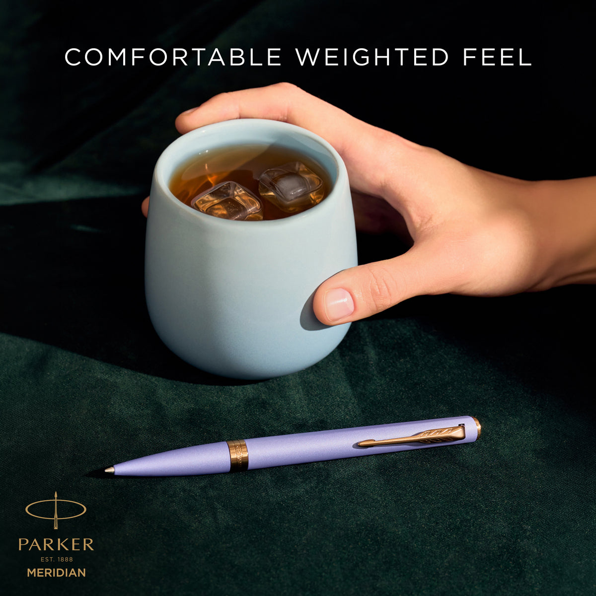 Hand writing with the lilac Meridian ballpoint, captioned comfortable weighted feel