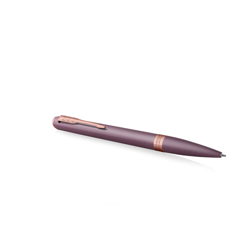 Purple Meridian ballpoint lying at an angle with the arrow clip on top and the pink gold PVD centre band visible
