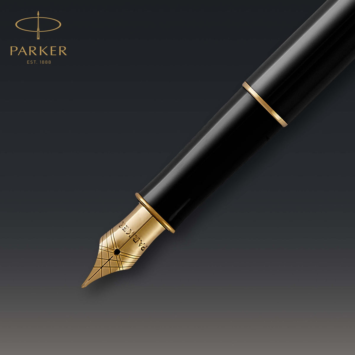 Close-up of the gold-toned nib and black section of the Sonnet against a dark background