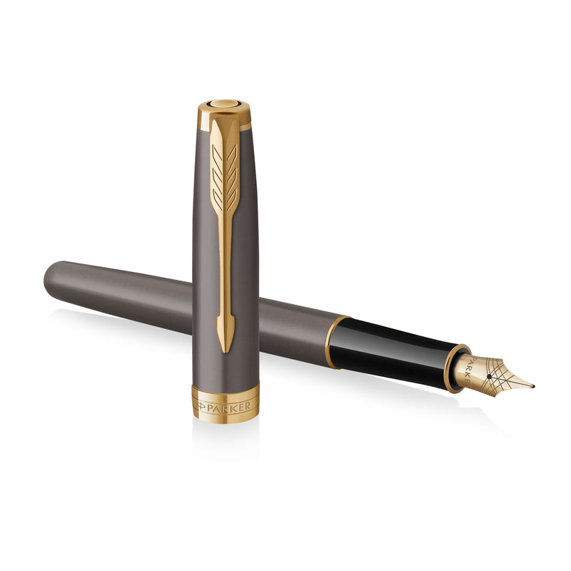 Uncapped grey Sonnet lying across its upright cap, nib to the right