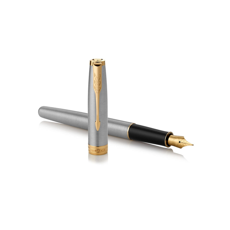 Uncapped steel and gold Sonnet lying across its upright cap with the nib to the right