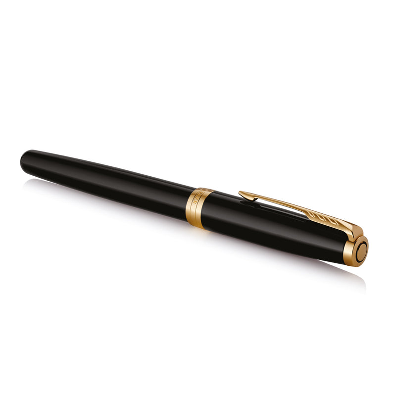 Capped black and gold Sonnet rollerball lying at an angle on white