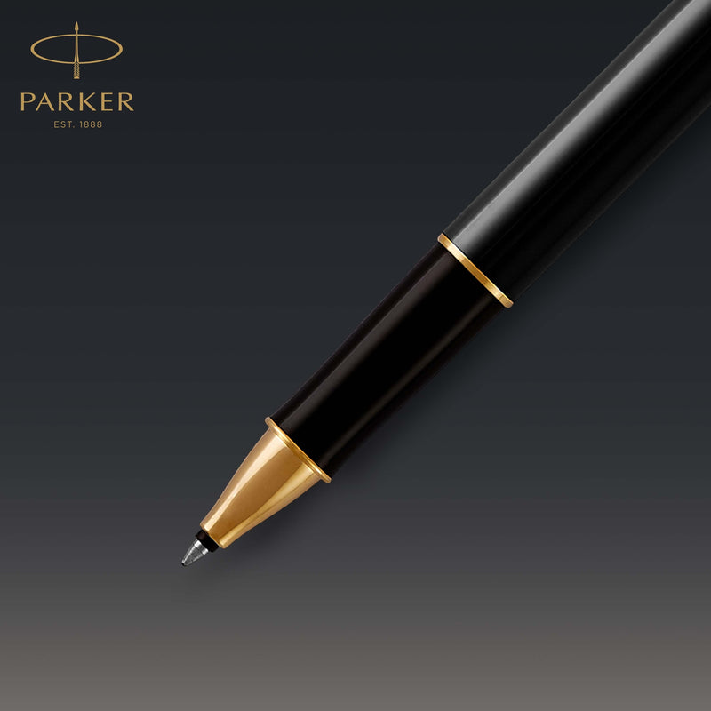 Close-up of the gold tip cone and fine rollerball tip against a dark background