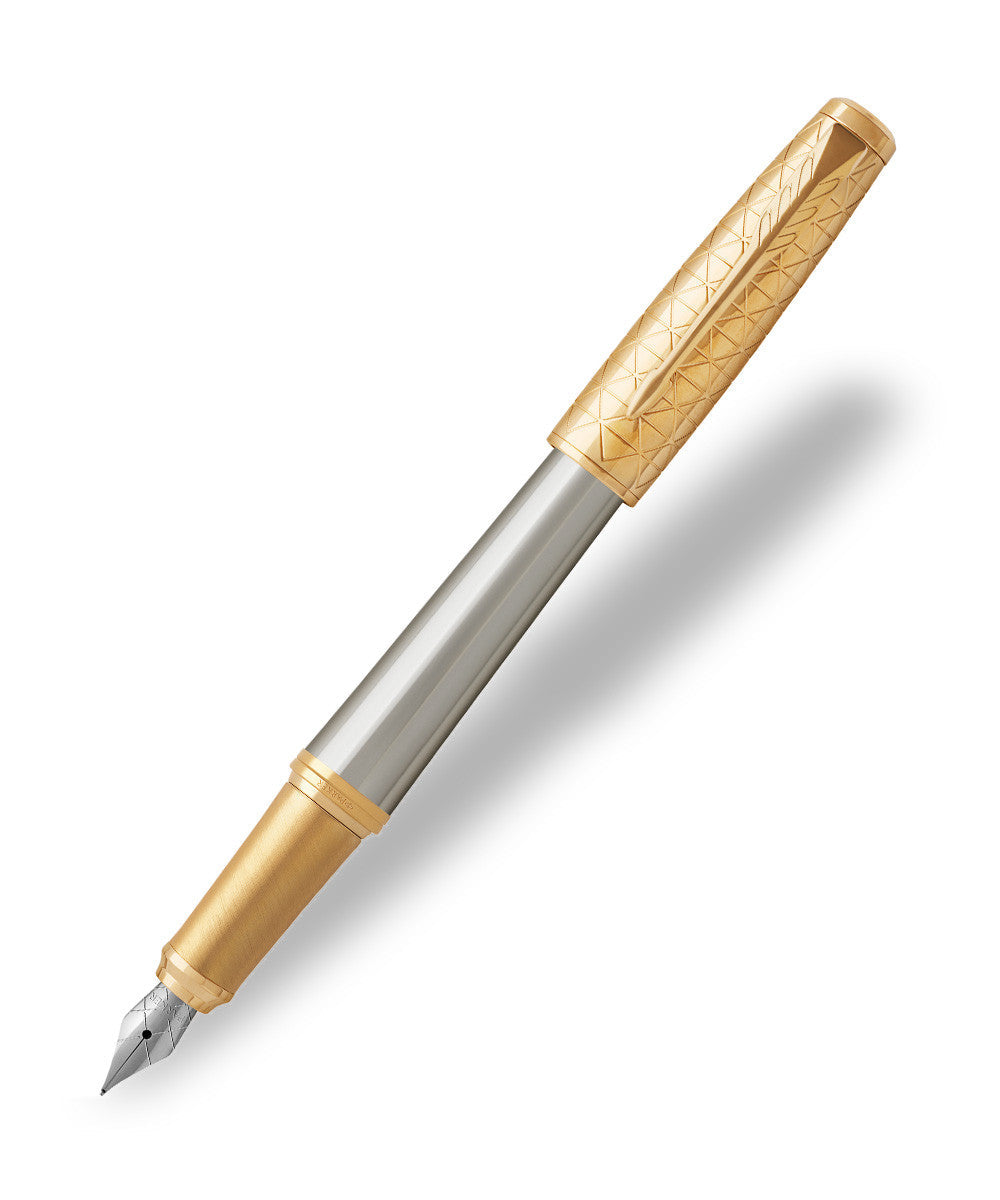 Parker Urban Premium fountain pen shown at an angle with the brushed steel barrel, engraved gold cap posted on the end and the stainless steel nib exposed against a white background.