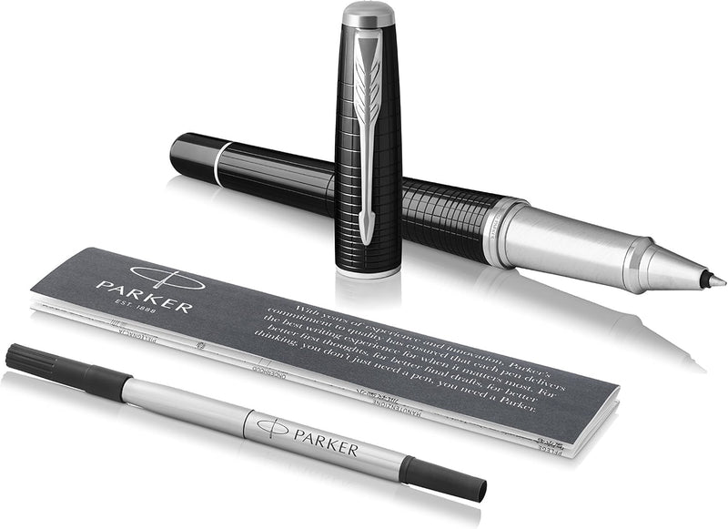 Parker Urban Premium rollerball pen laid beside a spare Parker rollerball refill and the printed Parker information card, showing what is supplied in the box.