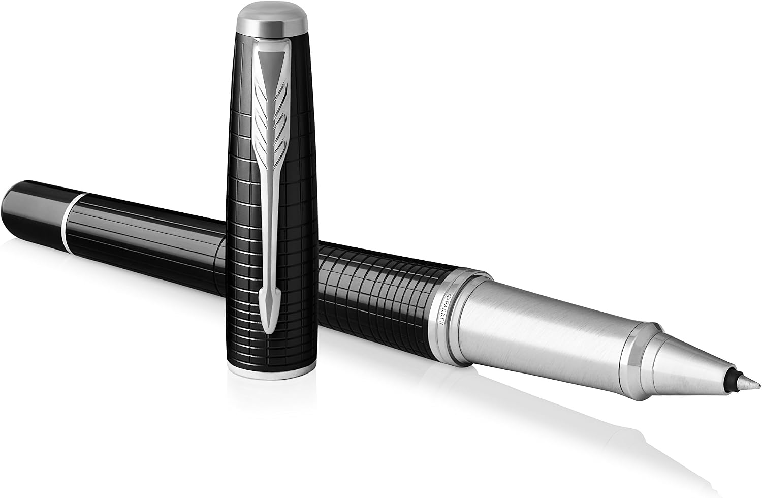 Parker Urban Premium rollerball pen uncapped and laid at an angle with the chiselled black barrel, chrome grip section and cap resting alongside on a white background.