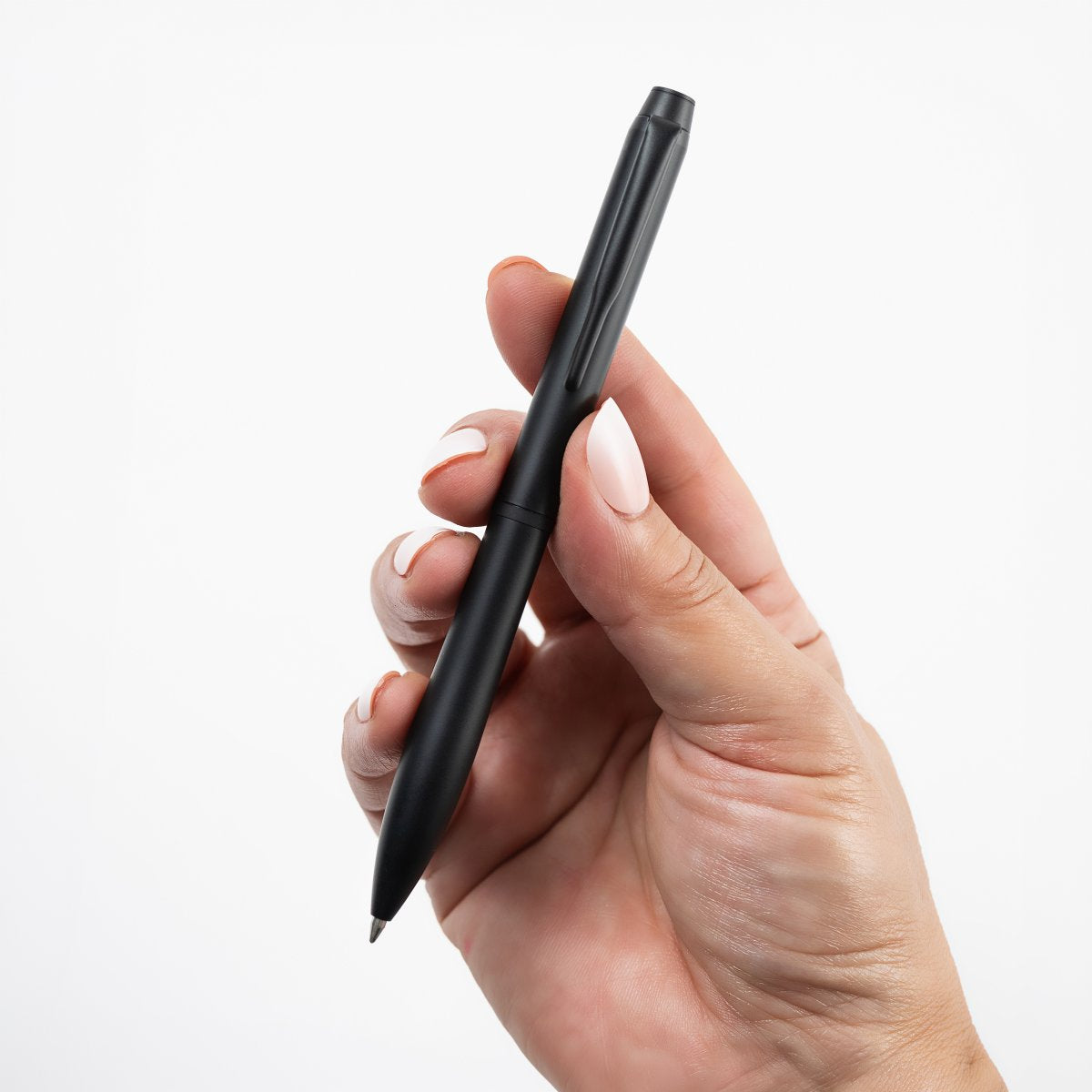 Pilot Eterlink retractable ballpoint pen in black held in a hand to show its size and proportions.