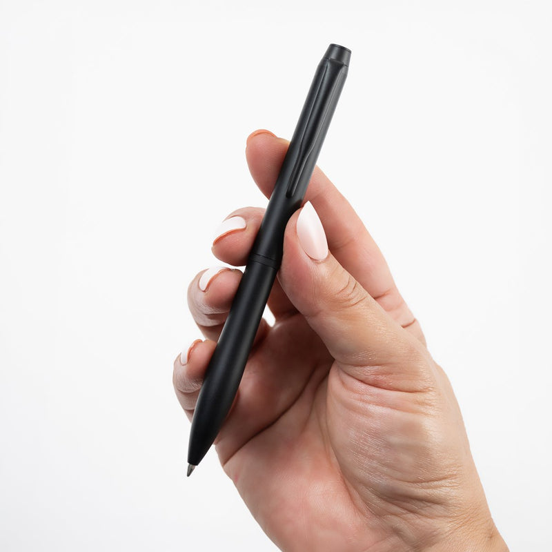 Pilot Eterlink retractable ballpoint pen in black held in a hand to show its size and proportions.