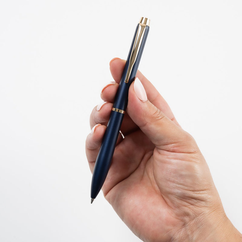 Pilot Eterlink retractable ballpoint pen in dark blue held in a hand to show its size and proportions.