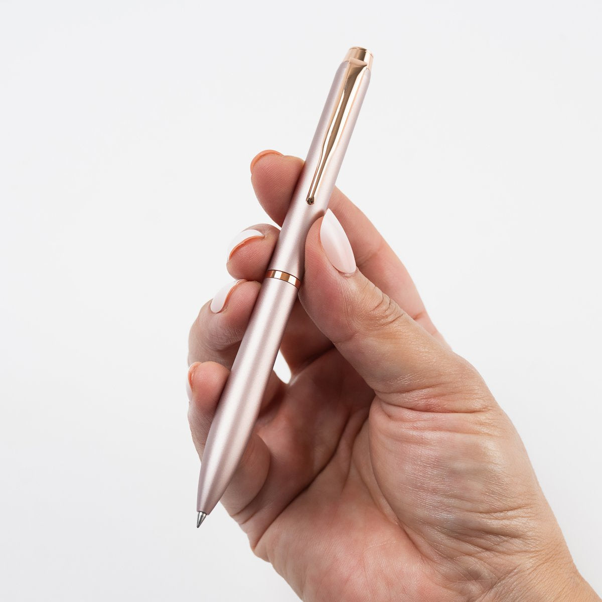 Pilot Eterlink retractable ballpoint pen in rose beige held in a hand to show its size and proportions.