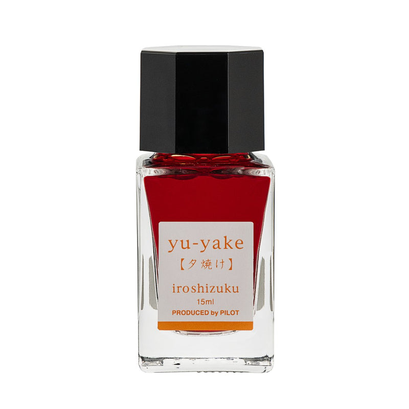 Pilot Iroshizuku 15ml bottle of Sunset Ink (Yu-yake) fountain pen ink, a faceted clear glass bottle of bottled ink shown upright on a white background.