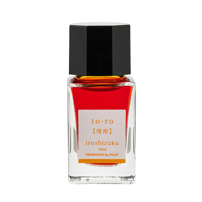Pilot Iroshizuku 15ml bottle of Warm Lantern (To-ro) fountain pen ink, a faceted clear glass bottle of bottled ink shown upright on a white background.