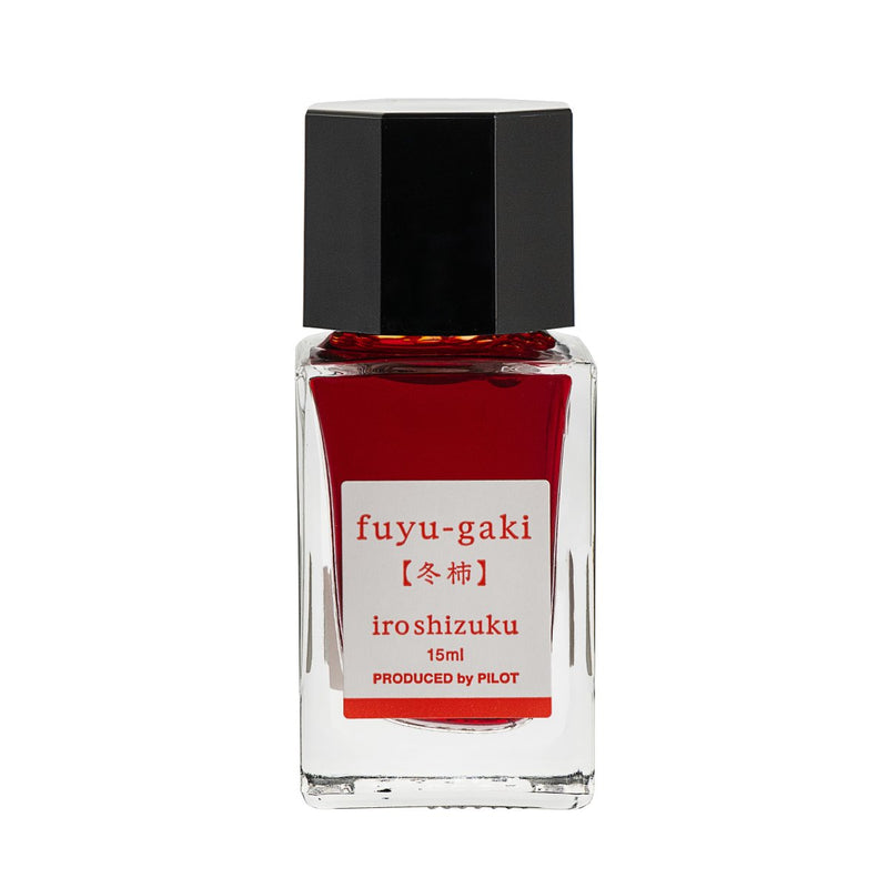 Pilot Iroshizuku 15ml bottle of Winter Persimmon Ink (Fuyu-gaki) fountain pen ink, a faceted clear glass bottle of bottled ink shown upright on a white background.
