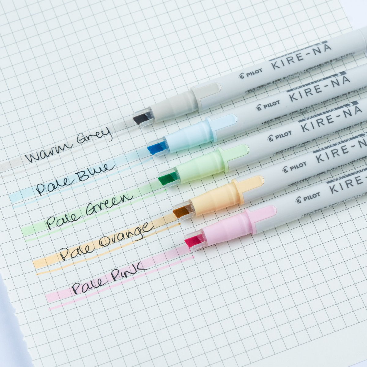 Pilot Kire-Na pastel colour dual tip highlighters in use on a page of handwritten notes, with a soft band of colour laid straight across a line of text