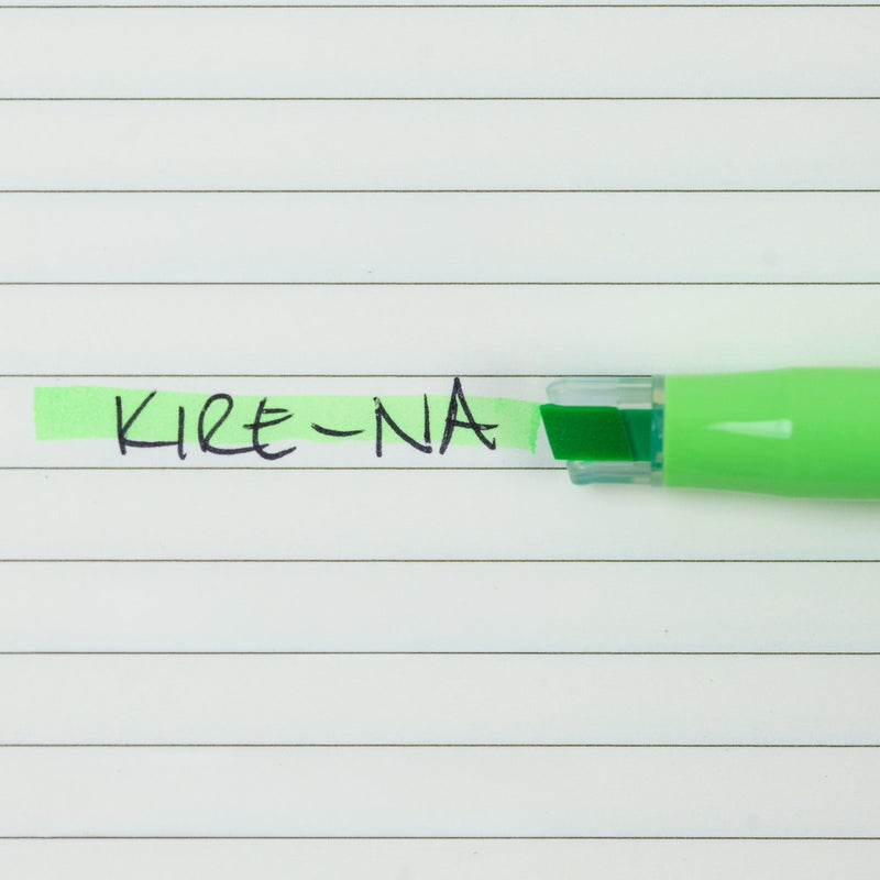 Pilot Kire-Na green dual tip highlighter in use on a page of printed notes, the broad chisel tip laying a straight band of green across a line of text