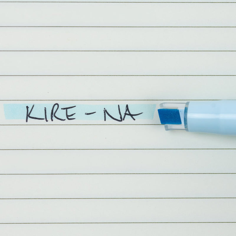 Pilot Kire-Na pale blue dual tip highlighter in use on a page of printed notes, the broad chisel tip laying a straight band of pale blue across a line of text