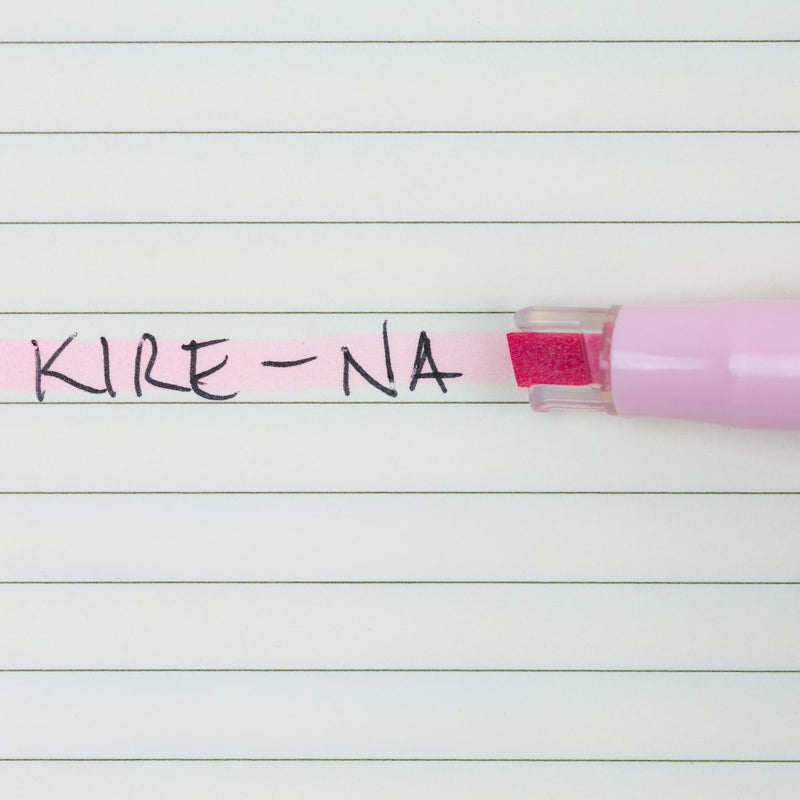 Pilot Kire-Na pale pink dual tip highlighter in use on a page of printed notes, the broad chisel tip laying a straight band of pale pink across a line of text