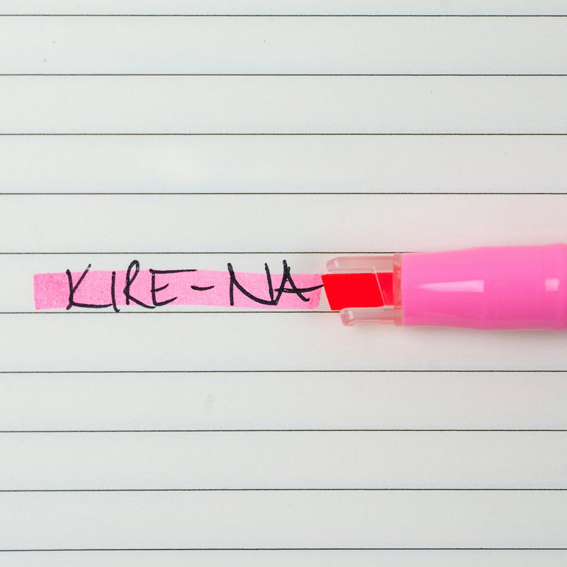 Pilot Kire-Na pink dual tip highlighter in use on a page of printed notes, the broad chisel tip laying a straight band of pink across a line of text
