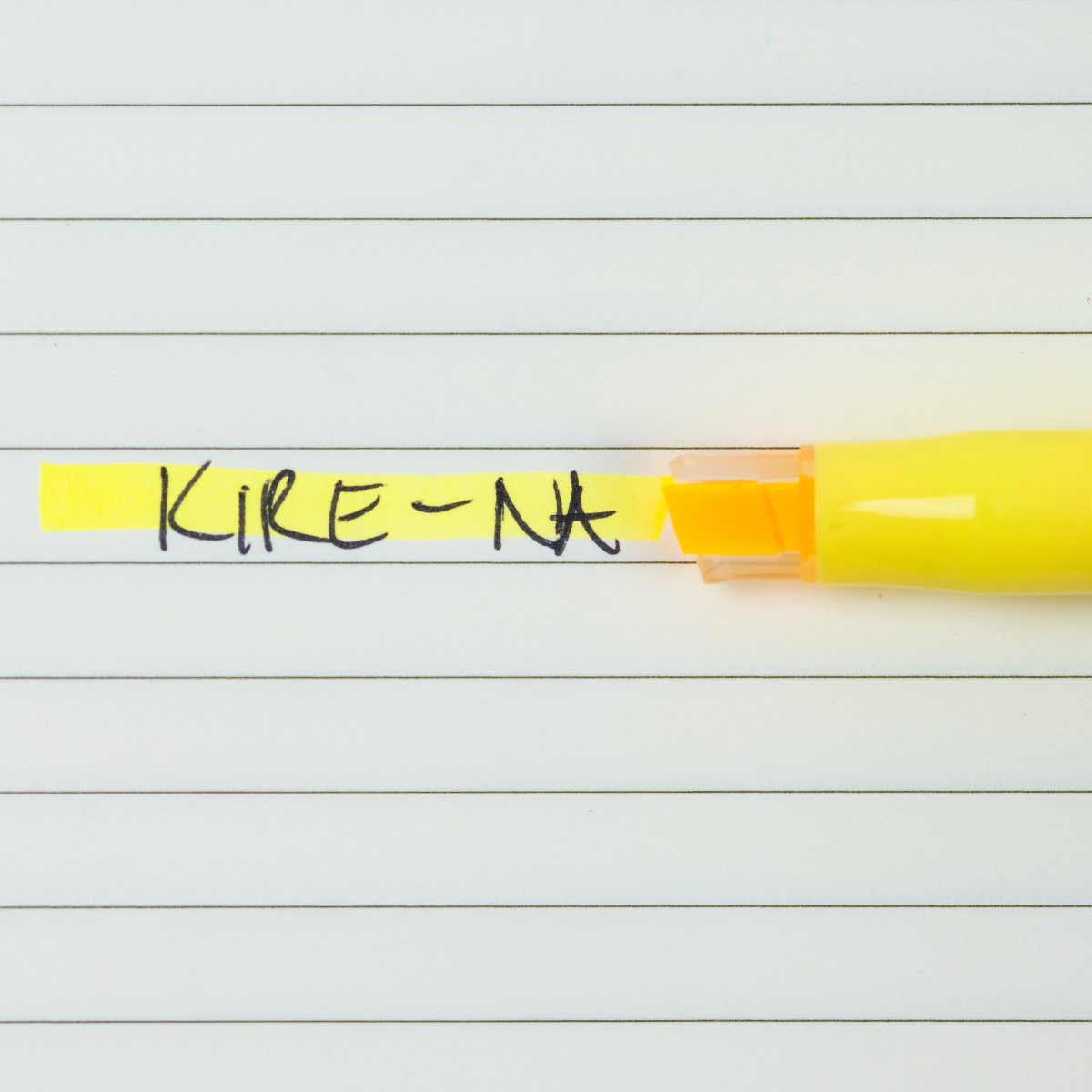 Pilot Kire-Na yellow dual tip highlighter in use on a page of printed notes, the broad chisel tip laying a straight band of yellow across a line of text