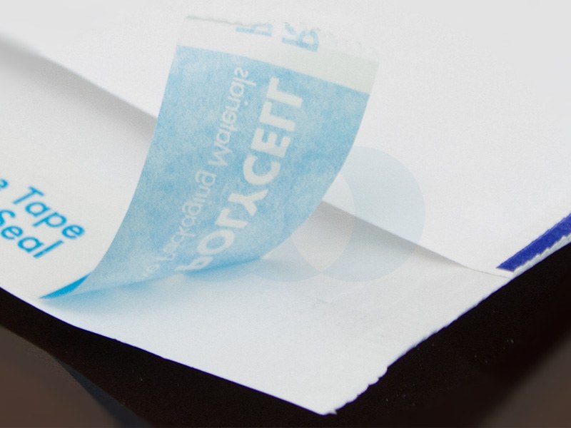 Close-up of a Polycell mailer flap with the blue release tape printed POLYCELL being peeled back to expose the seal