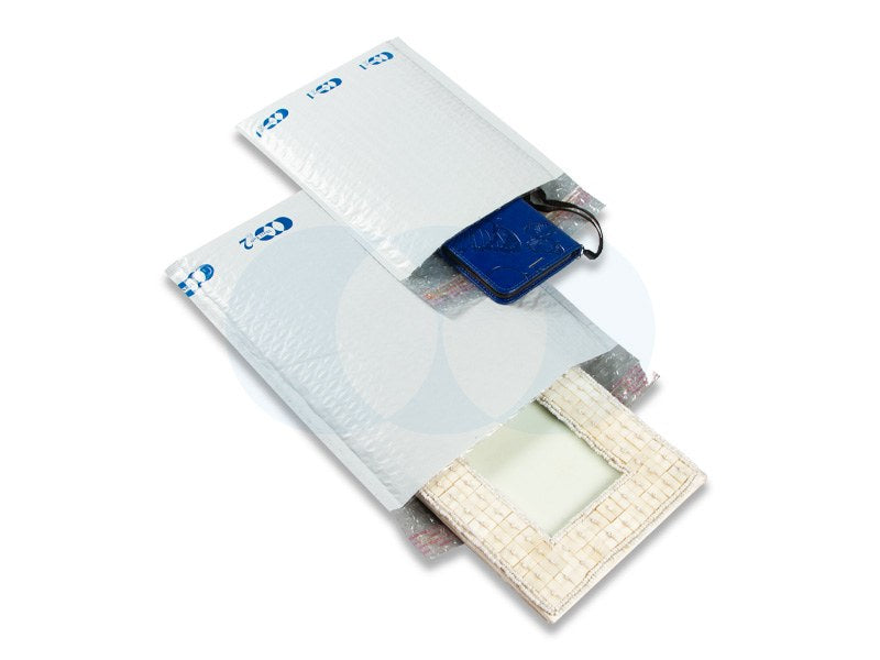 Polycell range photo of Maxi Tuff mailers with Polycell printing, holding a blue wallet and a woven photo frame