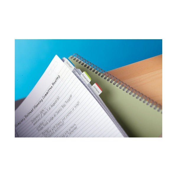 Spiral notebook with small Post-it tabs labelled along the page edge beside handwritten meeting notes