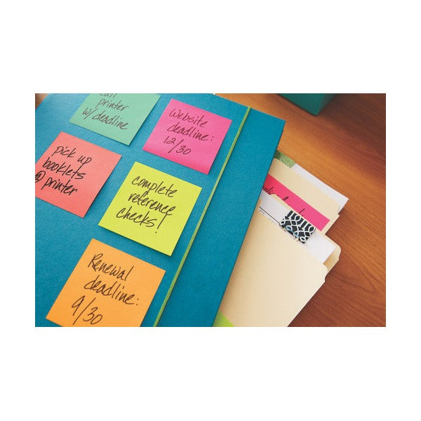 Cape Town colour Post-it notes handwritten with deadlines and reminders, stuck on a blue folder beside manila files