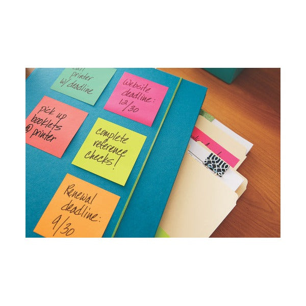 Cape Town colour notes with handwritten deadlines stuck on a blue folder next to manila files, shown for colour reference