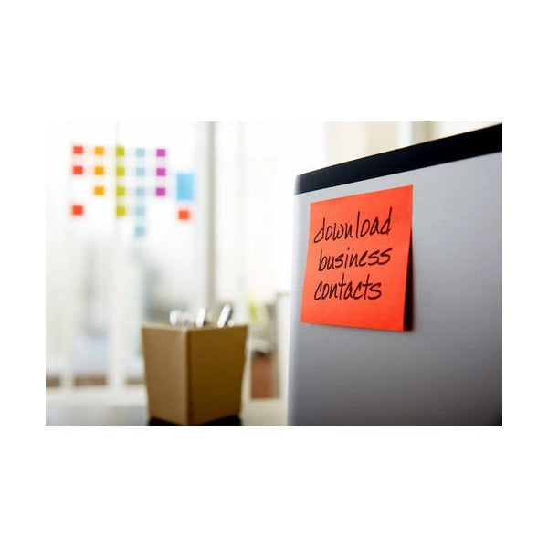 Red square Post-it note with download business contacts written in black stuck to a grey cabinet