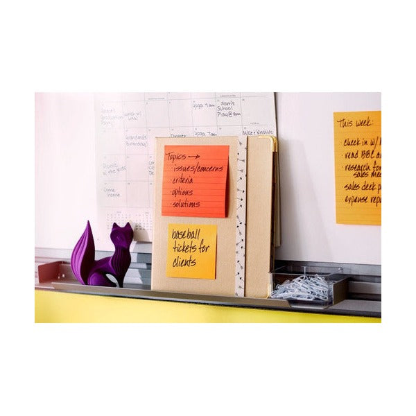 Lined orange notes with handwritten lists on a kraft board, a general Post-it scene showing lined notes, not this unlined pack