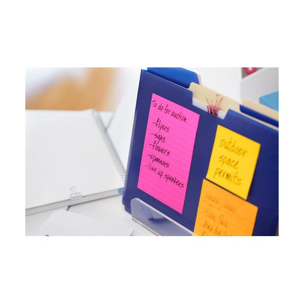 Pink and orange lined Post-it notes with a handwritten to-do list stuck to a blue folder beside a notebook