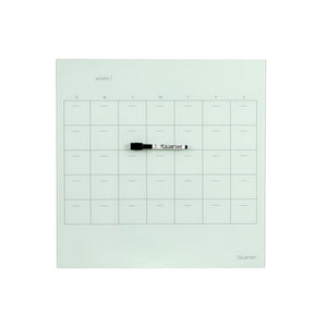 Quartet QTGP4343 frameless glass planner, front view of one board showing a month grid with day columns headed S M T W T F S, a MONTH label at the top, the Quartet logo at the lower right and a marker lying on the glass