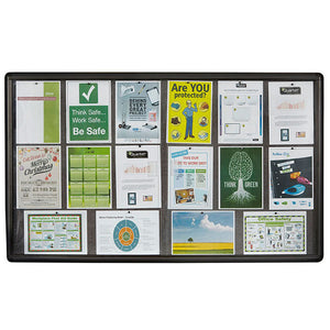 Wide Quartet enclosed notice case with a dark graphite frame and grey fabric holding rows of printed posters, a calendar, safety signs, a Christmas party flyer and charts behind the doors