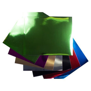 Fanned sheets of Quill Foil Board 510 x 635mm in assorted metallic colours, with a green foil sheet on top